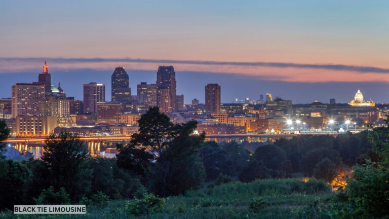 The Saint Paul skyline at dusk with golden city lights reflecting off the Mississippi River, showcasing the Twin Cities’ vibrant nightlife and urban elegance.